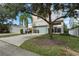 Spacious driveway with landscaping in front of two-story home at 1407 Fairview Cir, Reunion, FL 34747