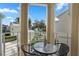 Private balcony with small table and chairs, overlooking a community pool at 1407 Fairview Cir, Reunion, FL 34747