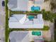 Aerial view of a house with a metal roof and pool in a residential neighborhood at 1407 Fairview Cir, Reunion, FL 34747