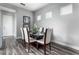 Bright dining room with glass table and six chairs, hardwood floors, and modern decor at 1407 Fairview Cir, Reunion, FL 34747