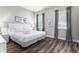 Spacious bedroom with king-size bed, hardwood floors, and gray accents at 1407 Fairview Cir, Reunion, FL 34747
