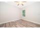 Bright bedroom with wood-look flooring and a ceiling fan at 250 S Virginia Ave, Deland, FL 32724