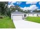 Two-story home with a white garage door and manicured lawn at 250 S Virginia Ave, Deland, FL 32724