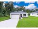 Modern one-story home with a two-car garage and landscaped lawn at 250 S Virginia Ave, Deland, FL 32724