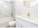 Clean bathroom with a white vanity, bathtub, and marble-look tile at 250 S Virginia Ave, Deland, FL 32724