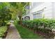 Landscaped walkway leading to a building with lush greenery at 12938 Penn Station Ct # 104, Orlando, FL 32821