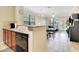 Open kitchen with granite countertops, stainless steel appliances, and wood cabinets at 909 Charo Pkwy # 1021, Davenport, FL 33897
