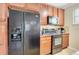 Kitchen area with black appliances and wood cabinets at 909 Charo Pkwy # 1021, Davenport, FL 33897