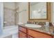 Clean bathroom with granite countertop, tiled shower, and bathtub at 909 Charo Pkwy # 1021, Davenport, FL 33897