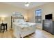 Bright bedroom with a queen bed, TV, and plenty of natural light at 909 Charo Pkwy # 1021, Davenport, FL 33897