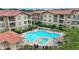 Overlooking the community pool and spa, this view shows the building's architecture at 909 Charo Pkwy # 1021, Davenport, FL 33897