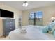 Main bedroom with a dresser, king-size bed, and large window at 909 Charo Pkwy # 1021, Davenport, FL 33897