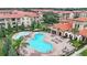 Community pool and spa with ample lounge chairs and landscaping at 909 Charo Pkwy # 1021, Davenport, FL 33897