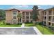 Multi-story building with stone accents and lush landscaping at 909 Charo Pkwy # 1021, Davenport, FL 33897