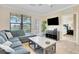 Open living room with sectional sofa and access to bedroom at 909 Charo Pkwy # 1021, Davenport, FL 33897