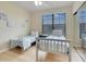 Guest bedroom with two twin beds, ample closet space, and window at 909 Charo Pkwy # 1021, Davenport, FL 33897