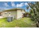 AC unit and backyard with cactus and grass at 7414 Rose Ave, Orlando, FL 32810