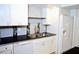 Close-up of the kitchen's double sink and white cabinetry at 2649 Crown Ct # 2649, Kissimmee, FL 34741