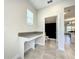 Well-lit laundry room with washer, dryer, and built-in counter at 13041 Inkwell Aly, Winter Garden, FL 34787