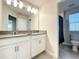 Double vanity bathroom with shower and toilet at 13041 Inkwell Aly, Winter Garden, FL 34787