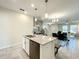 Modern kitchen island with a breakfast bar and stainless steel appliances at 13041 Inkwell Aly, Winter Garden, FL 34787