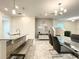 Open concept kitchen and dining area, featuring modern appliances and a breakfast bar at 13041 Inkwell Aly, Winter Garden, FL 34787