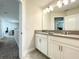 Double vanity bathroom with modern light fixtures at 13041 Inkwell Aly, Winter Garden, FL 34787
