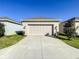 Single-car garage with light beige door and concrete driveway at 13041 Inkwell Aly, Winter Garden, FL 34787