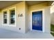 Inviting home exterior featuring a stylish blue front door and neutral color palette at 13041 Inkwell Aly, Winter Garden, FL 34787