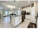 Modern kitchen with white cabinets, stainless steel appliances and a large island at 13041 Inkwell Aly, Winter Garden, FL 34787
