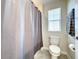Clean bathroom with shower/tub combo and gray shower curtain at 13041 Inkwell Aly, Winter Garden, FL 34787