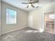 Well-lit bedroom with carpet flooring and an adjacent bathroom at 13041 Inkwell Aly, Winter Garden, FL 34787