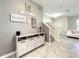 Stylish entryway with a modern console table and staircase at 13041 Inkwell Aly, Winter Garden, FL 34787