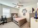 Bright bedroom with a twin-size bed and built-in desk at 13041 Inkwell Aly, Winter Garden, FL 34787