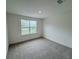 Spacious bedroom with carpet and a large window at 2949 Sunset Dr, New Smyrna Beach, FL 32168