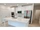 Modern kitchen with white cabinets and island at 2949 Sunset Dr, New Smyrna Beach, FL 32168