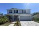 Two-story house with gray siding and stone accents at 2949 Sunset Dr, New Smyrna Beach, FL 32168