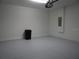 Spacious garage with painted floor and projector at 3025 Ballad Rd, Kissimmee, FL 34746