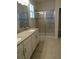 Bathroom with double vanity, glass shower, and tile floors at 3025 Ballad Rd, Kissimmee, FL 34746
