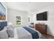 Comfortable bedroom with a blue upholstered bed and large TV at 634 Burch Ave, Winter Garden, FL 34787