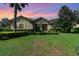 One-story home with stone accents and manicured lawn at 25822 Feather Ridge Ln, Sorrento, FL 32776