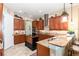 Kitchen with island, granite countertops, and ample wood cabinetry at 25822 Feather Ridge Ln, Sorrento, FL 32776