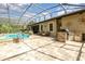 Outdoor kitchen with stonework, grill, and ample counter space at 25822 Feather Ridge Ln, Sorrento, FL 32776