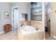 Bathroom with soaking tub, walk-in shower, and elegant tile work at 25822 Feather Ridge Ln, Sorrento, FL 32776