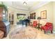 Elegant living room featuring a piano, and comfortable seating near a view of the backyard at 25822 Feather Ridge Ln, Sorrento, FL 32776