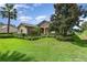 One-story home with stone accents and manicured hedges at 25822 Feather Ridge Ln, Sorrento, FL 32776