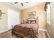 Guest bedroom with a queen-size bed, window, and built-in closet at 25822 Feather Ridge Ln, Sorrento, FL 32776