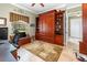 Home office with built-in wooden wall unit and window seat at 25822 Feather Ridge Ln, Sorrento, FL 32776