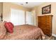 Bedroom with double doors and a large wooden dresser at 25822 Feather Ridge Ln, Sorrento, FL 32776