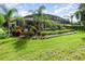 Landscaped backyard with a screened pool and tropical plants at 25822 Feather Ridge Ln, Sorrento, FL 32776